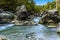 The Alcantara river flows between large volcanic boulders near Taormina, Sicily