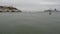 Alcatraz island in San Francisco Bay, California USA. Federal prison for gangsters on rock, foggy weather. Historic jail, cliff in