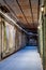 Alcatraz Prison old hallway inside the barracks apartment with rusty walls, ceiling grills and pipes