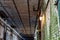 Alcatraz Prison old hallway inside the barracks apartment with rusty walls, ceiling grills and pipes