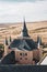 Alcazar of Segovia fairy-tale towers, Spanish Gothic architecture watchtowers with fields in the background, Spain