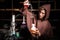 Alchemist in chemical laboratory prepares magical liquids