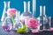 alchemy and aromatherapy set with rose flowers and chemical flasks