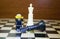 ALCOBENDAS, SPAIN July 23, 2020: Lego minifigure scared by the defeat of the black king in a chess move. Concept of defeat in