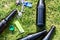 Alcohol bottles, cigarette lighter and keys on grass