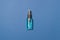 Alcohol clean hand sanitizer in bottle on blue colored paper background