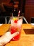 Alcohol coctail drink with cherry, lime and lollipop straw on the table in restaurant