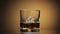 Alcohol drink whiskey, cognac into glass with ice cubes. Dark background.
