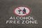 Alcohol free zone sign on pavement