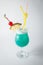 Alcohol fresh blue curacao coctail with pineapple and berry on w