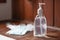 Alcohol sanitizer gel and medical face mask on table, closeup