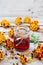 Alcohol tincture of marigolds in jar on old wooden board