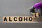 alcohol word written on wood block. alcohol text on table, concept