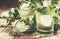 Alcoholic cocktail mint tea with rum in small glasses with ice on vintage wood background, selective focus