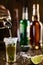 An alcoholic drink at the bar counter is poured into a tequila glass with salt at the edges, in the background are