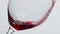 Alcoholic drink pouring clear wineglass closeup. Red wine filling clear glass