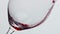 Alcoholic drink pouring clear wineglass closeup. Red wine filling clear glass