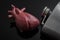 Alcoholic heart failure and damage or cardiomyopathy concept with a heart next to a metal flask of alcohol. Cardiomyopathy is a