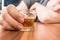 Alcoholic man is sleeping on table. Glass with alcohol in hand