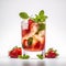 Alcoholic mojito cocktail with fresh red strawberries, green mint leaves and lime slices in a transparent glass