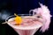 Alcoholic pink cocktail in a martini glass with straw