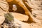 Alcove with window weathered from the sandstone arch looking out over the Arizona desert