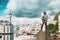 Alesund, Norway. Statue Of Young Sailor-fisher Boy On Brosundet Canal. Old Wooden Houses In Summer Day