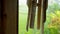 Alex Closeup of old wooden wind chimes swing on a terrace during persistent breeze outside. Traditional vintage