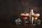 Alexander cocktail in cocktail glass on wooden table with shaker, nutmeg and small grater with Christmas decor on dark background