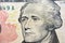 Alexander Hamilton portrait on the banknote of 10 dollars, ten American dollars background, selective focus, united states dollars