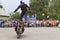 Alexei Kalinin rides standing on a motorbike. Moto show in Verkhovazhye, Vologda region, Russia