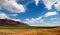 Alfalfa hayfield and wheat field under cumulus clouds in Wyoming