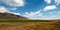 Alfalfa hayfield and wheat field under cumulus clouds in Wyoming