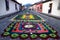 Alfombre flower carpets on the cobbled streets along colonial buildings of Antigua, Guatemala