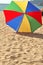 Algarve Portugal. Highly coloured fully raised beach umbrella lying on a sunny beach