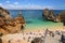ALGARVE, PORTUGAL - MAY 29, 2018: Tourists visit Camilo Beach in Algarve region, Portugal. Coastal region of Algarve attracts more