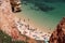 ALGARVE, PORTUGAL - MAY 29, 2018: Tourists visit Camilo Beach in Algarve region, Portugal. Coastal region of Algarve attracts more