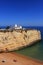 Algarve, Portugal. Typical historical chapel with whitewashed walls against a blue sky.