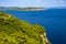 Alghero, Sardinia, Italy - Panoramic view of the Gulf of Alghero with cliffs of Punta del Giglio and city of Alghero in background