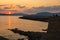 Alghero, Sardinia, Italy - Summer sunset landscape over the Gulf of Alghero at Mediterranean Sea - with cliffs of Capo Caccia cape