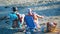 Alicante, Spain, August 25, 2019: Two senior women seated at the beach solving crosswords while tanning