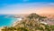 Alicante town, beach, sea port and Santa Barbara Castle on Benacantil hill from Serra Grossa mountain at sunset. Vivid