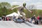 alien athlete performing high-profile trick on skateboard during competition