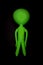 Alien. Blank inflatable little green man. Stereotypical body shape isolated against black background.