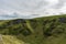 Alien-like rocky hills covered in a green moss and grass