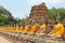 Aligned buddha statues with orange bands