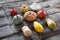 Alignment of colorful seasonal organic pumpkins over rustic wood background