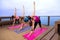 Alignment pose yoga class row outdoor location retreat attractive thin fit women