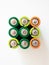Alkaline batteries on white background, above. Concept recycling waste and environmental pollution