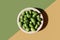 Alkaline diet, nature balance concept. Cucamelon in granite plate on double diagonal background. Organic design, green yellow